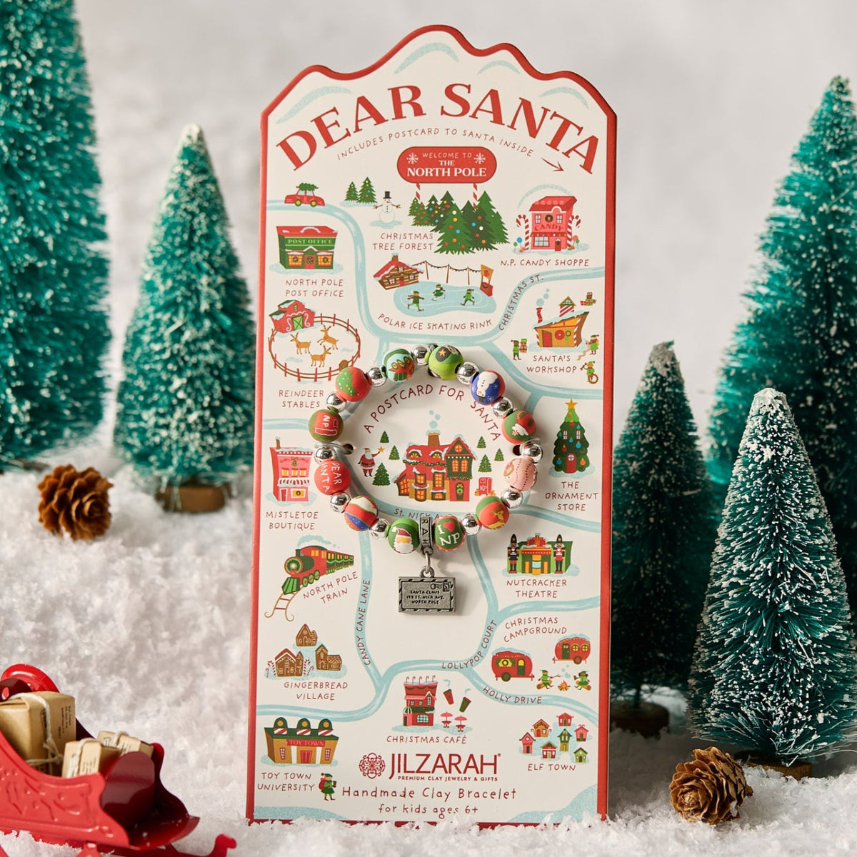 Dear Santa kids bracelet on its illustrated card, styled with miniature evergreen trees and snow